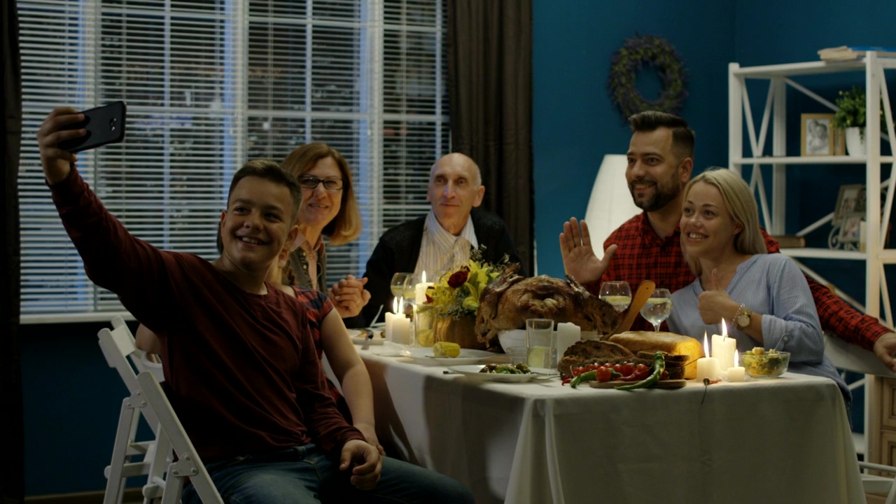 A family taking a selfie on thanksgiving dinner, celebration, home activity, dinner, selfie, table, family dinner, turkey, and thanks giving