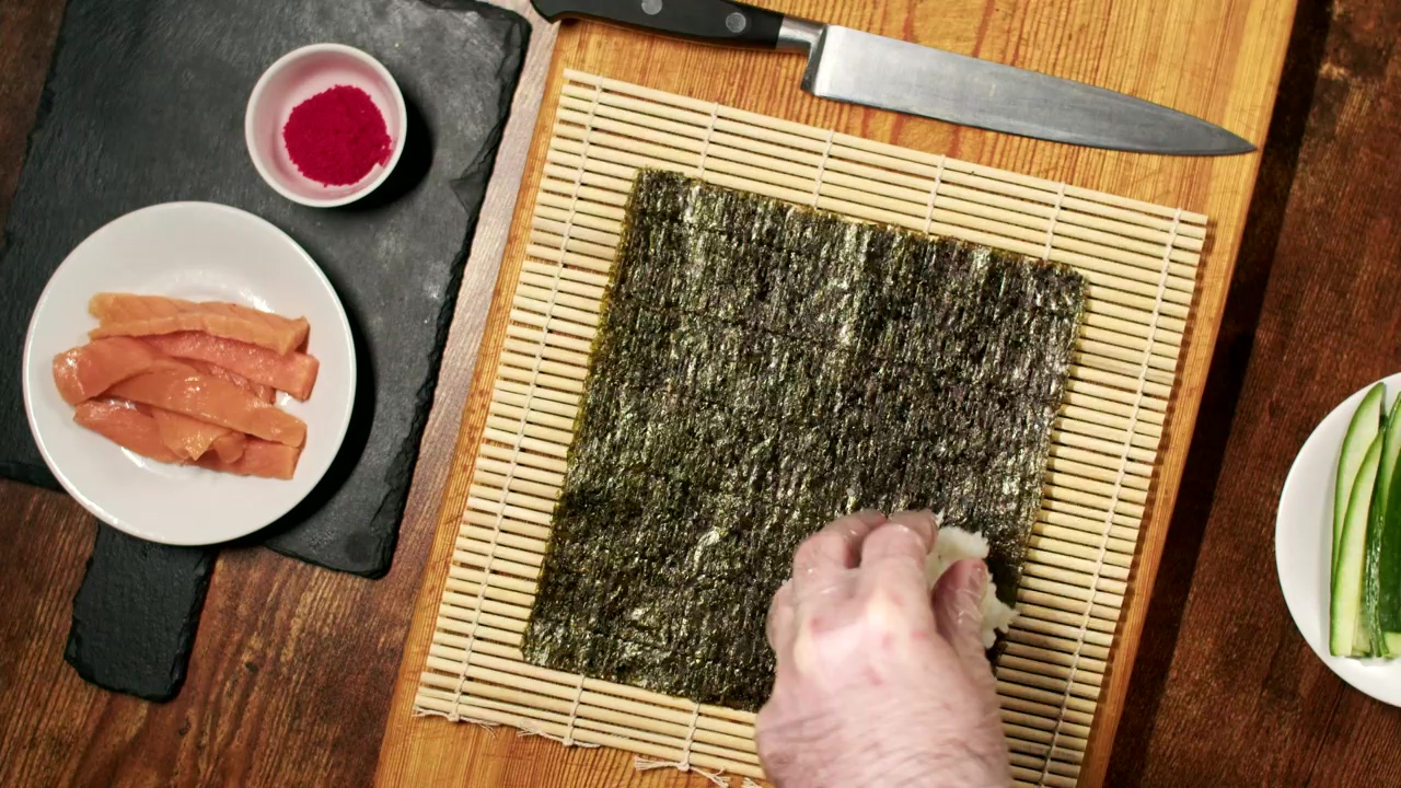 Chef assembling a roll of fresh sushi #food #food preparation #chef #fish #japan #sushi #japanese #seafood #japanese food