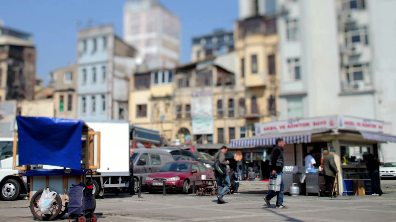 Fish market in a pedestrian area near a parking zone with unfocused buildings at the bottom of the video