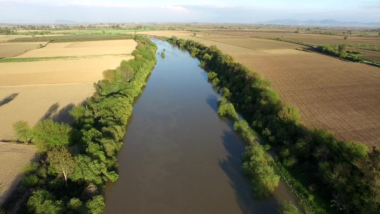 Flying over a river between agricultural fields, aerial, river, agriculture, and fly