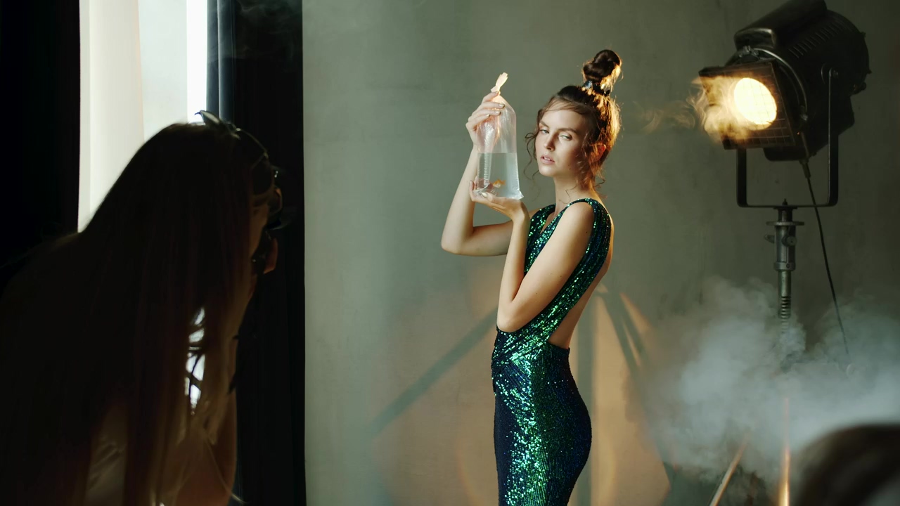 Model holds goldfish in bag for photo shoot, fashion, model, photo studio, fish, shooting, and light leak