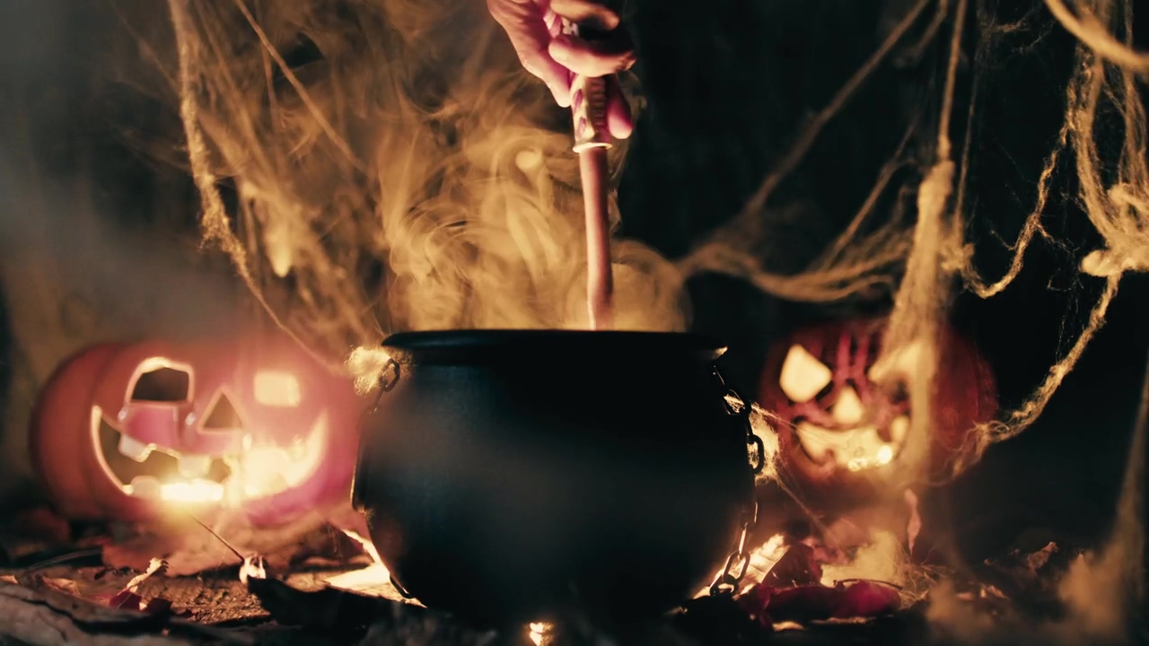 Pot with potion and a hand stirs it and with a spiders wed, halloween, web, and spider
