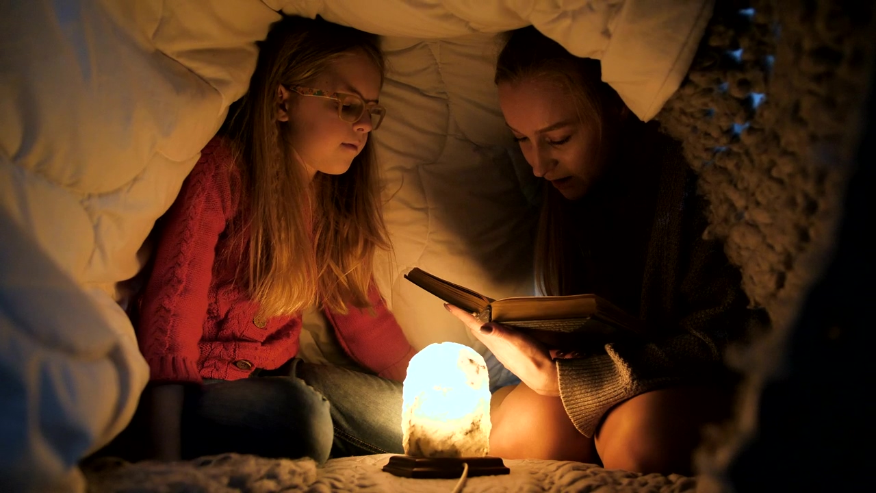 Reading a book in a blanket fort, book, bed, sleep, and lamp
