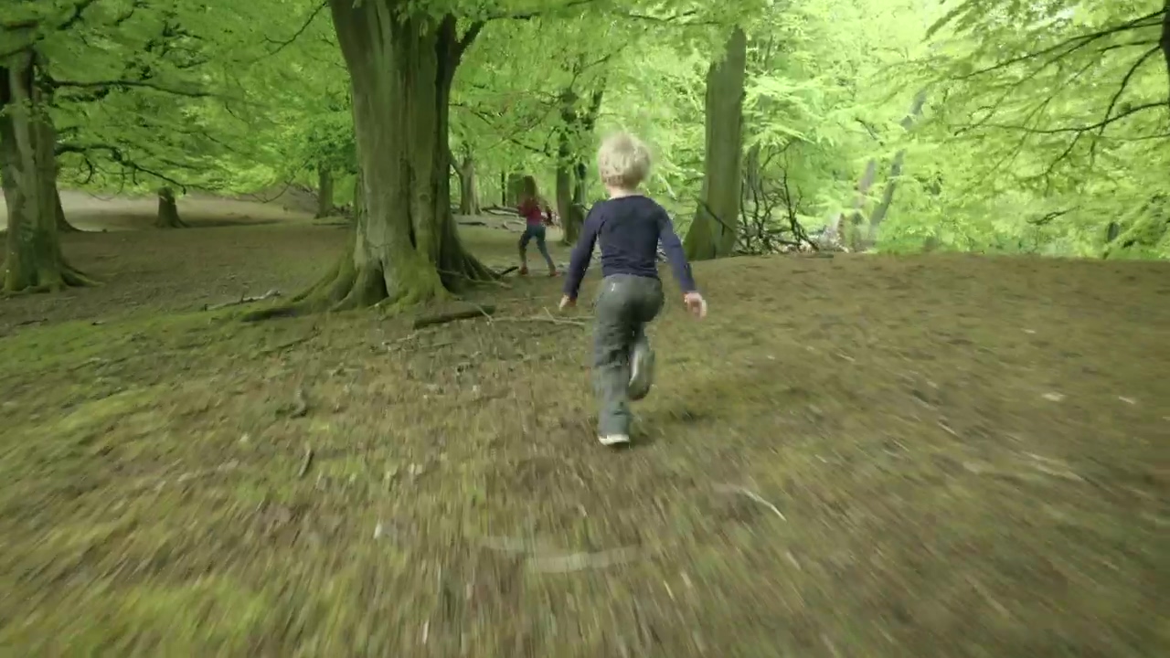 Two kids running from wild deer, kid and deer