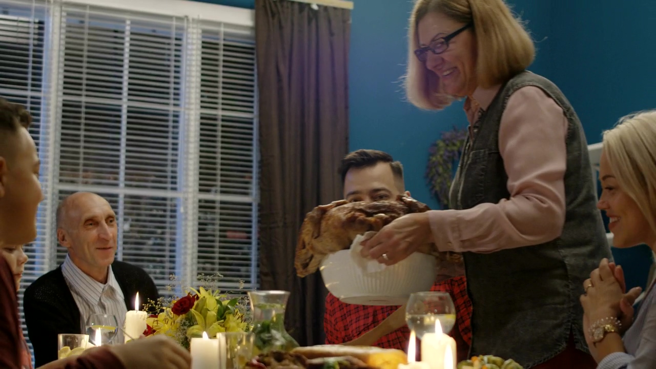 Woman bringing the turkey to the table, food, family, dinner, table, family dinner, turkey, and food delivery